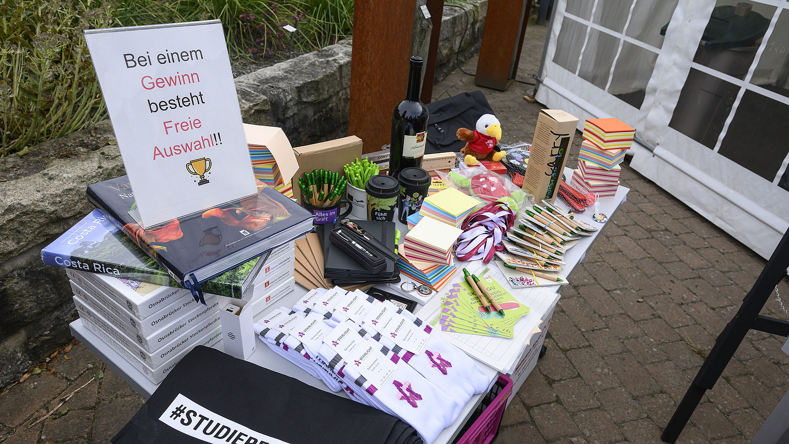 A table with various colorful objects including books, blocks, and pens.