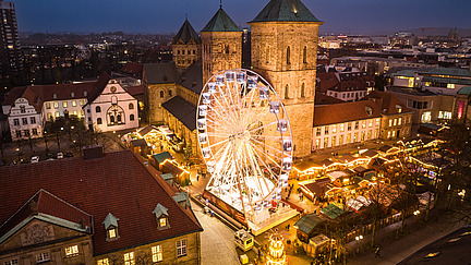 Osnabrück Christmas market at dusk on the market square in front of the cathedral.