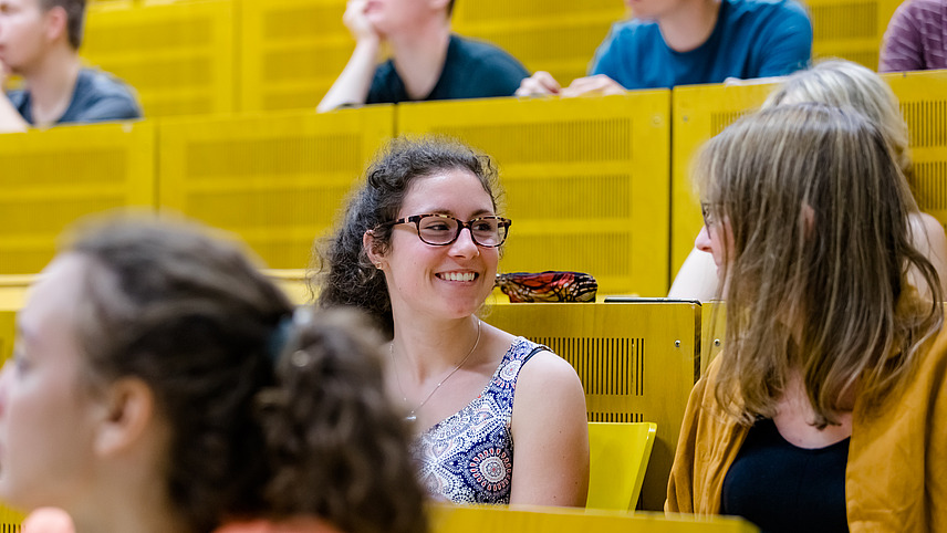 View of students across the rows of seats in a lecture hall.