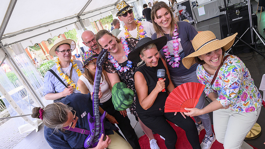 A group of people in colorful costumes poses for a photo.