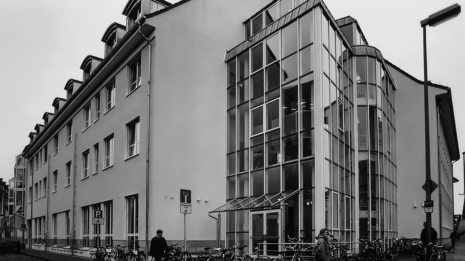 Black and white photo with a view of the glazed entrance area of the building