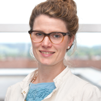 Portrait of a woman with glasses and pinned up hair