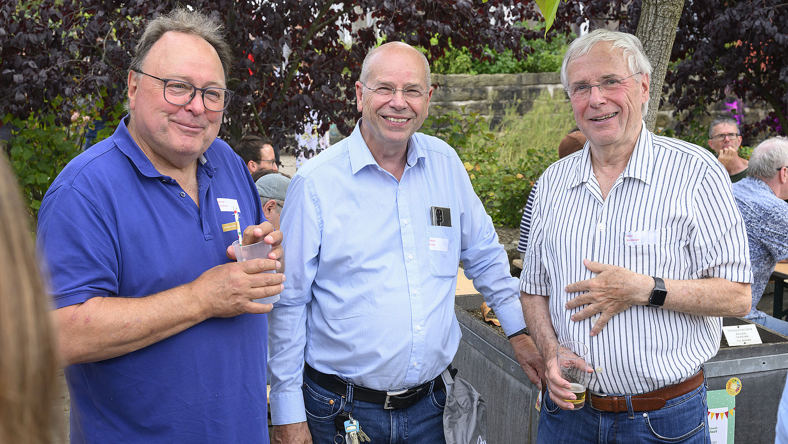 Three men are laughing into the camera.