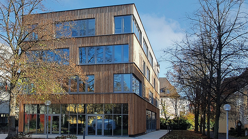 View of the student center. The facade of the building looks like wood and the windows are irregularly spaced.