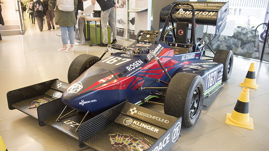 Pupils explore a racing car at the university information day