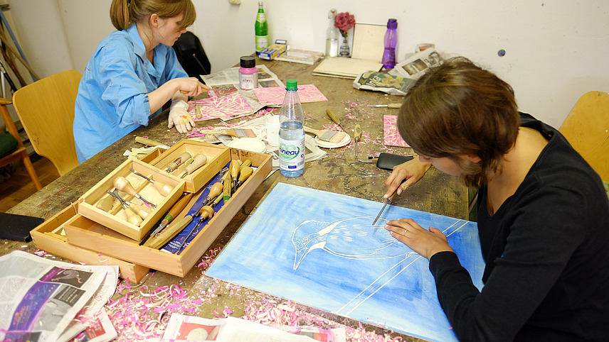 Two artists work at one table