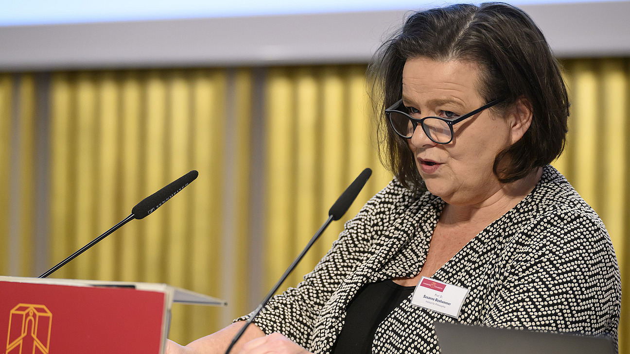 A woman speaks into the microphone.