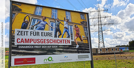 Ein großes Werbeplakat auf dem Studierende auf der Treppe des Schlosses in die Luft springen. Die Aufschrift lautet "Zeit für eure Campusgeschichten. Osnabrück freut sich auf euch!".